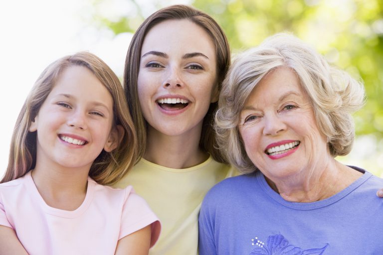 grandmother with adult daughter and grandchild in park HKSlQACHi